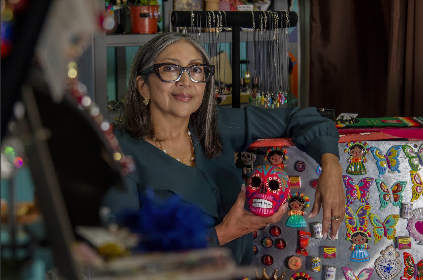 Leti inside Lolita on Blanco holding a colorful candy skull